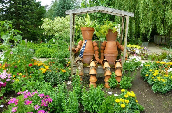 Flower-pot-men-as-focal-point-in-small-garden-design.jpg